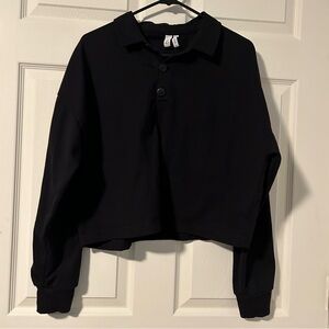 A by Zella size Medium crop with three buttons and collar in black.